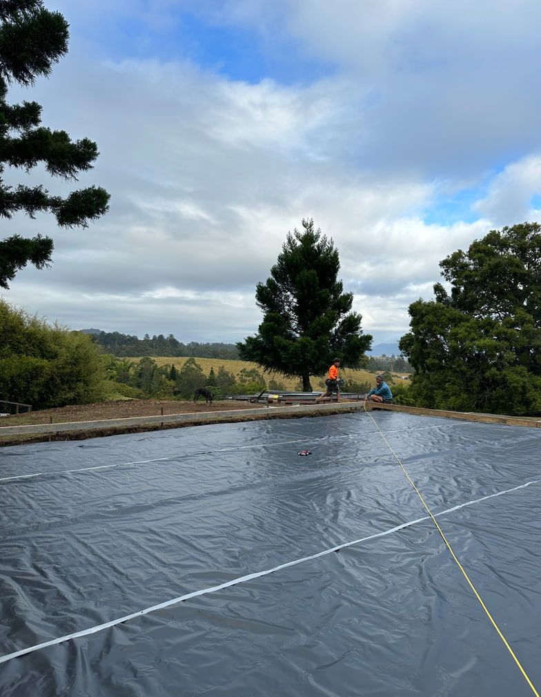 A Large Black Tarp Is Covering A Basketball Court — Hinterland Concreting Pty Ltd In Casino, NSW
