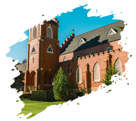 Brick church with tower, arched windows, and green lawn against a blue sky.