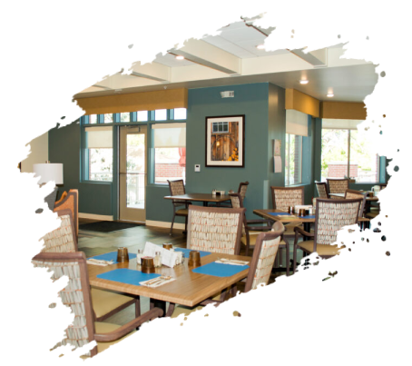 Restaurant dining area with tables set. Blue walls, tan accents, and large windows.