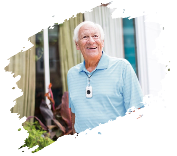 Smiling elderly man wearing a medical alert pendant outside a building.