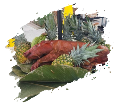 Roasted pig surrounded by pineapples and banana leaves. Outdoor setting.