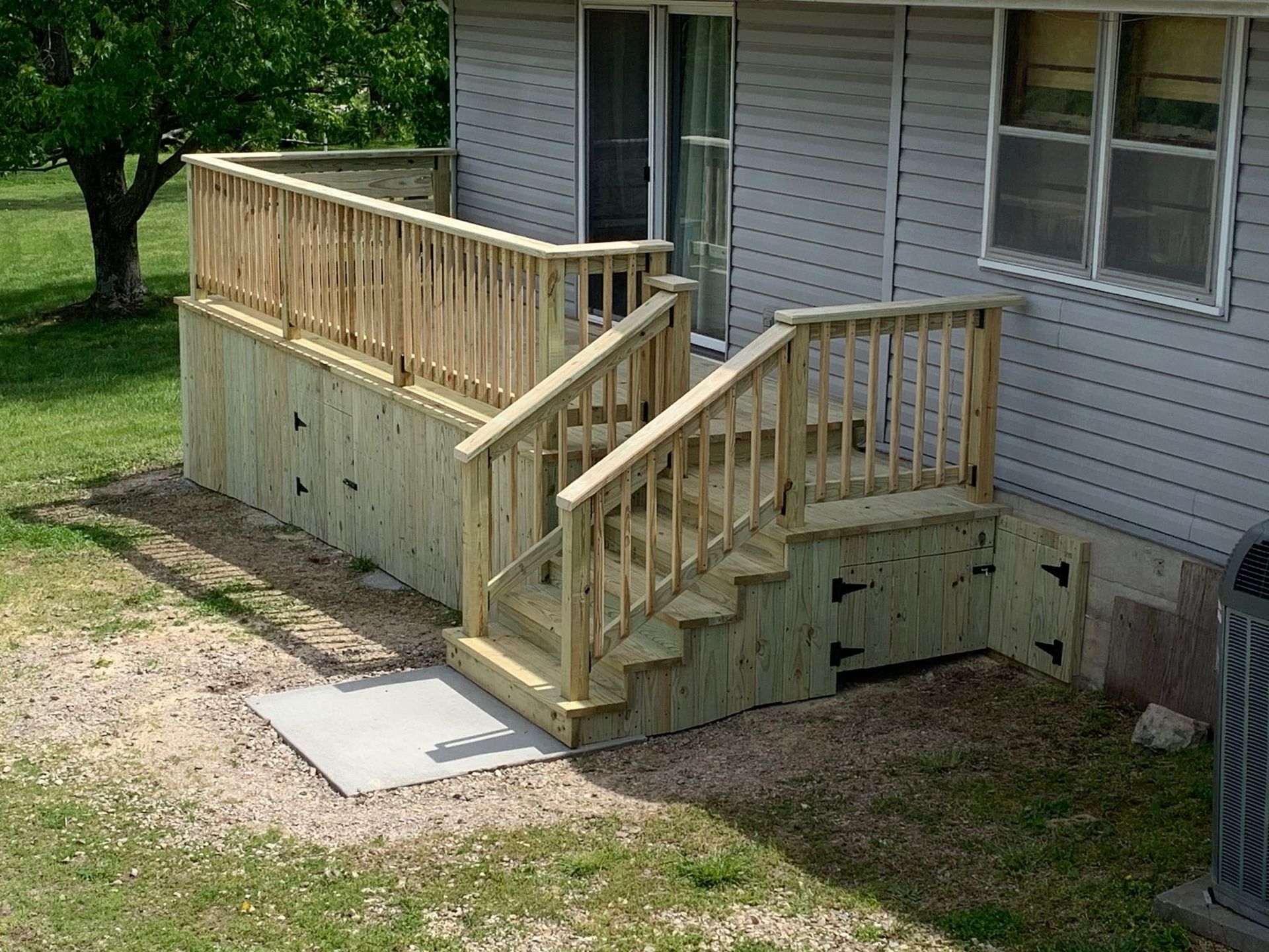 A Wooden Deck with Stairs Leading up To It — Columbia, MO — Naugle Construction Company