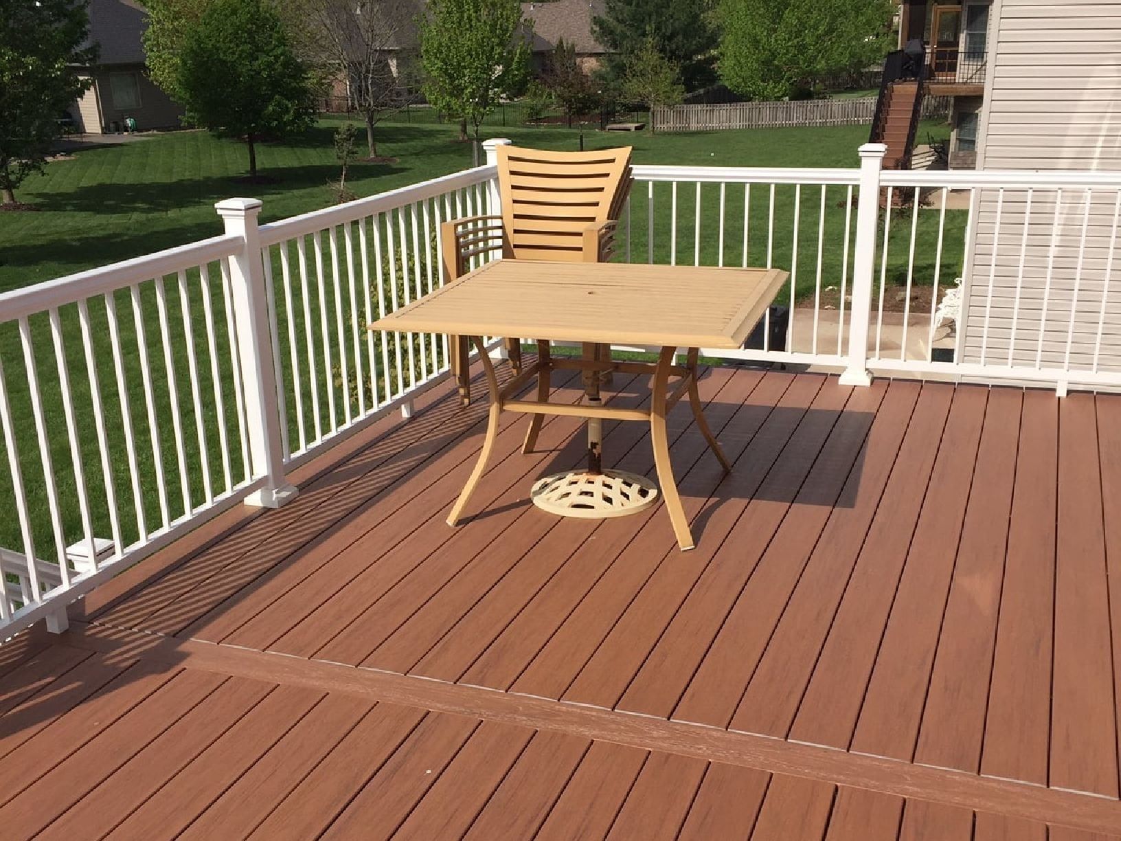 A Wooden Deck with A Table and Chairs on It — Columbia, MO — Naugle Construction Company