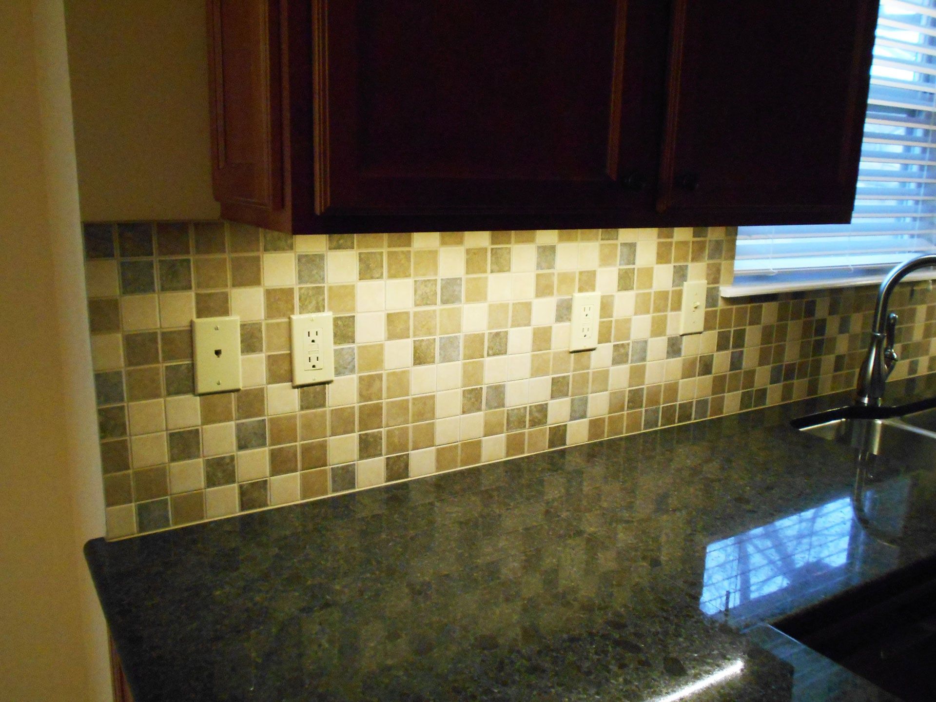 A Kitchen with A Sink and A Window with Blinds — Columbia, MO — Naugle Construction Company