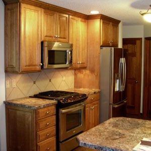 Kitchen with Stainless Steel Appliances and Wooden Cabinets — Columbia, MO — Naugle Construction Company