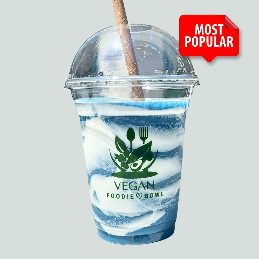 A cup of vegan foodie bowl with a straw in it
