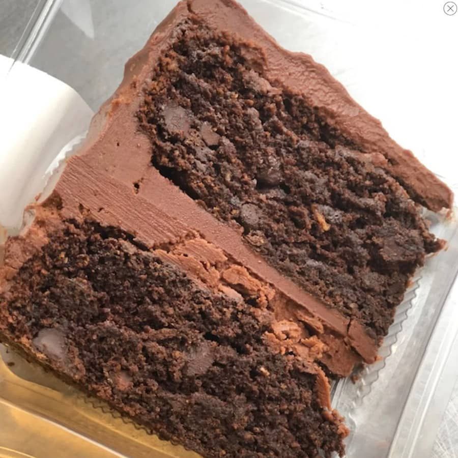A slice of chocolate cake in a plastic container