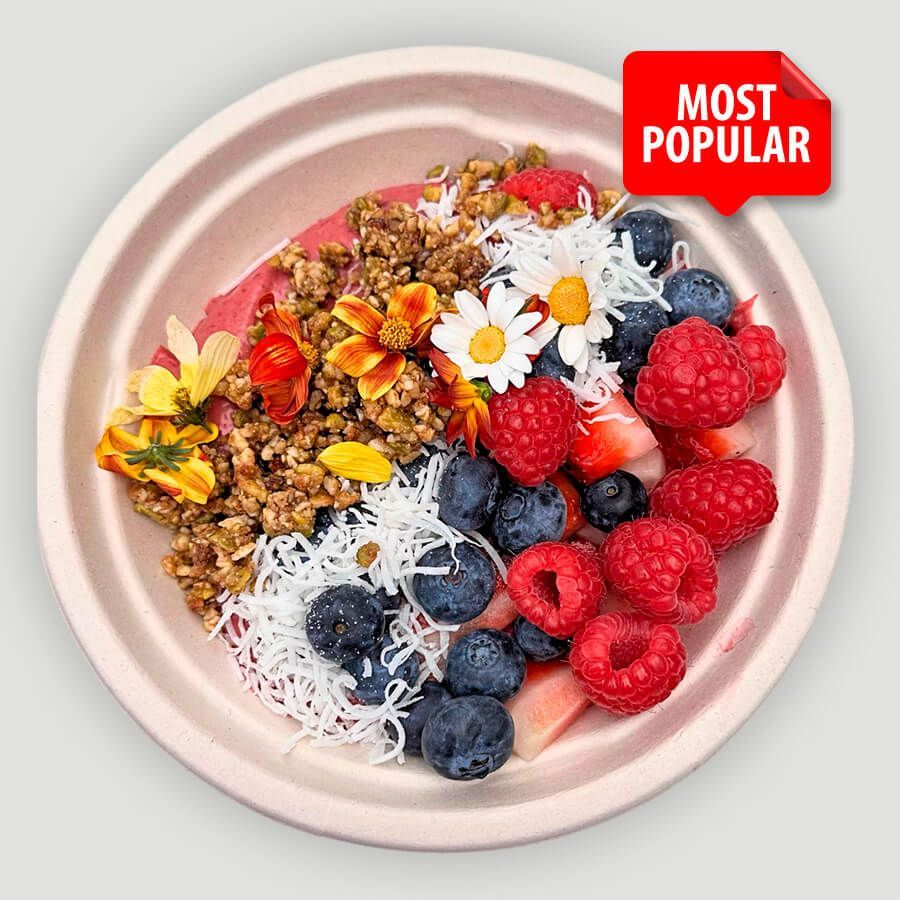A bowl of berries and granola with a most popular sticker on it