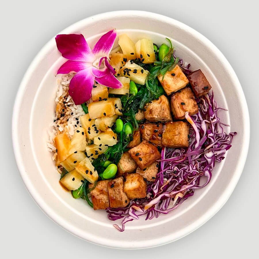 A bowl of food with a flower on top of it.