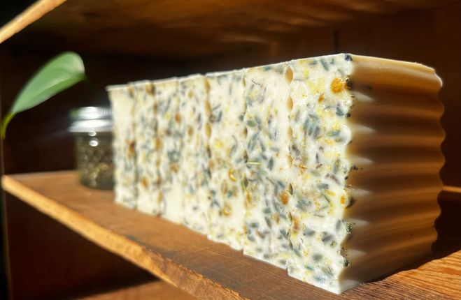 Bars of soap on wooden shelf 