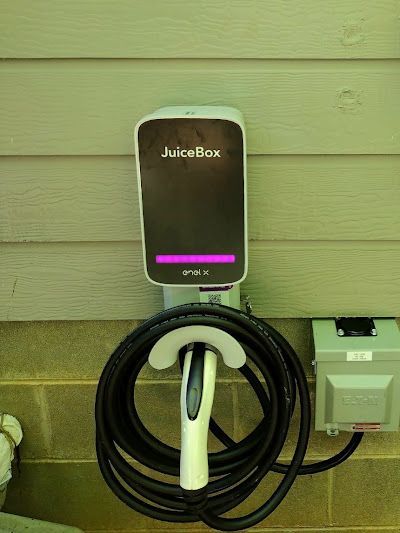A juicebox charging station is attached to a brick wall