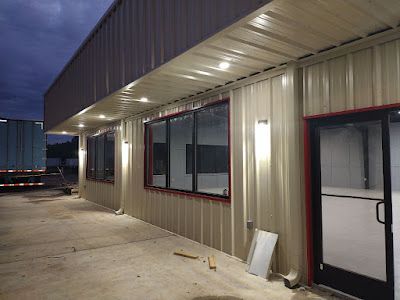 A large building with a lot of windows and a door.
