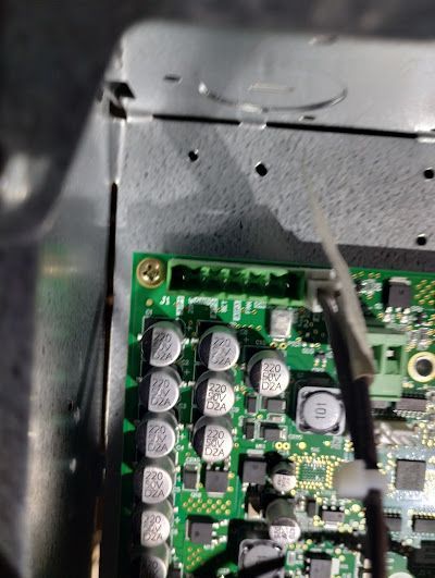 A close up of a motherboard with a lot of capacitors on it.