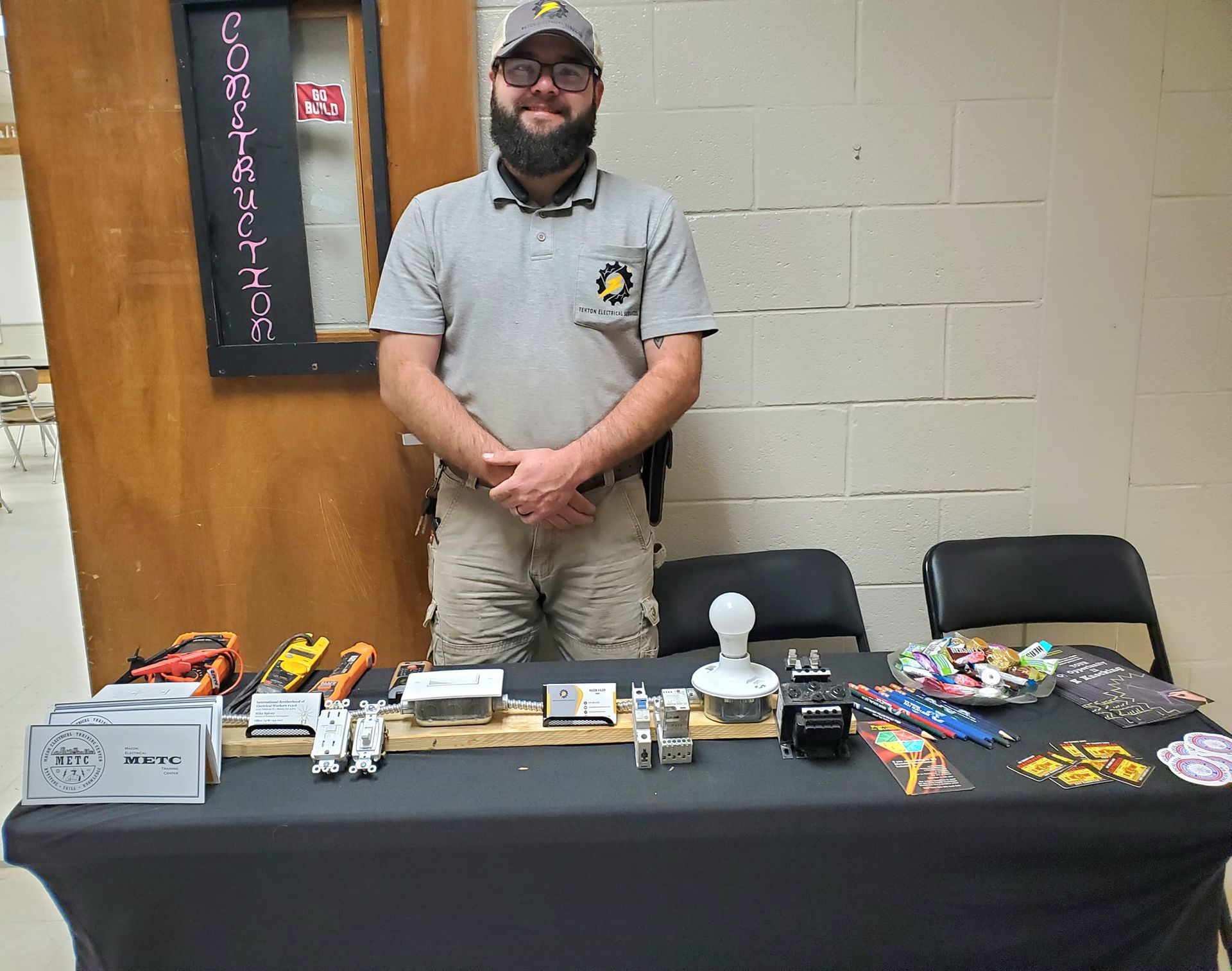 A man is standing in front of a table with toys on it.