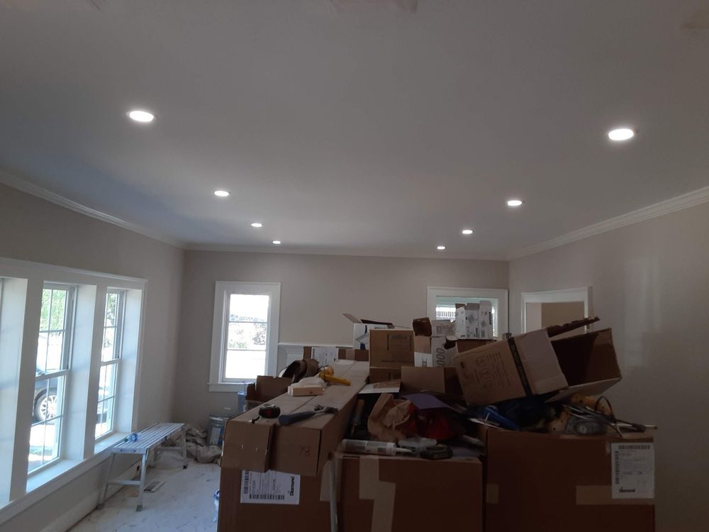 A living room filled with lots of cardboard boxes.