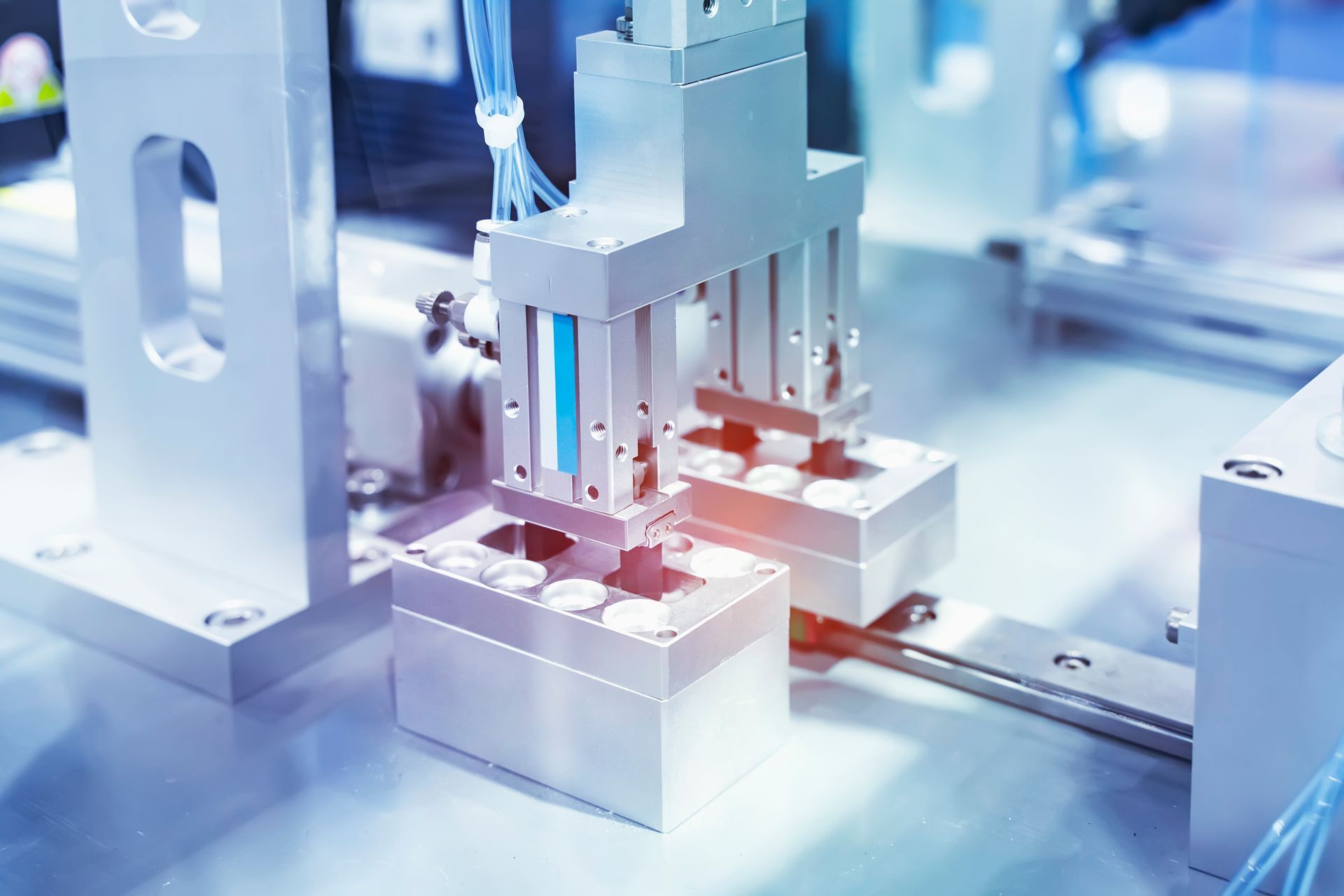 Robotic pneumatic piston sucker unit on industrial machine.