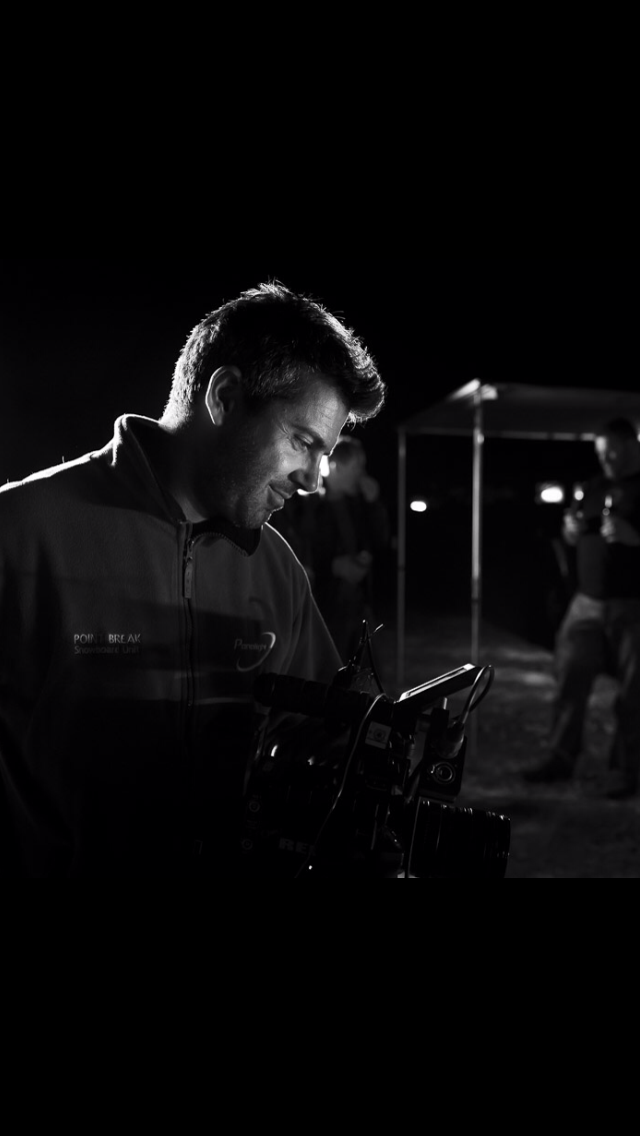 A black and white photo of a man looking down at something