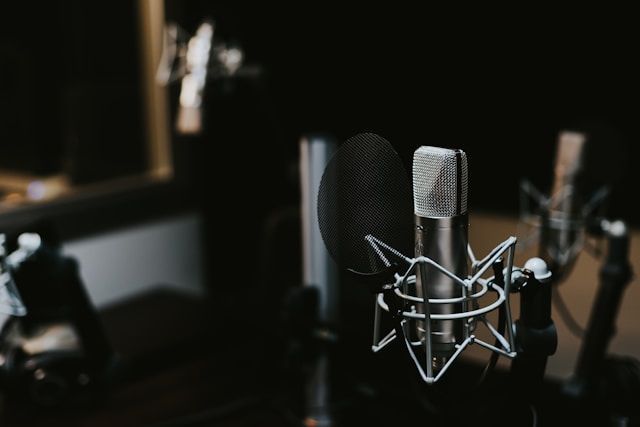 Professional setup for podcast production featuring recording equipment, soundproofing materials, and a mixing console.
