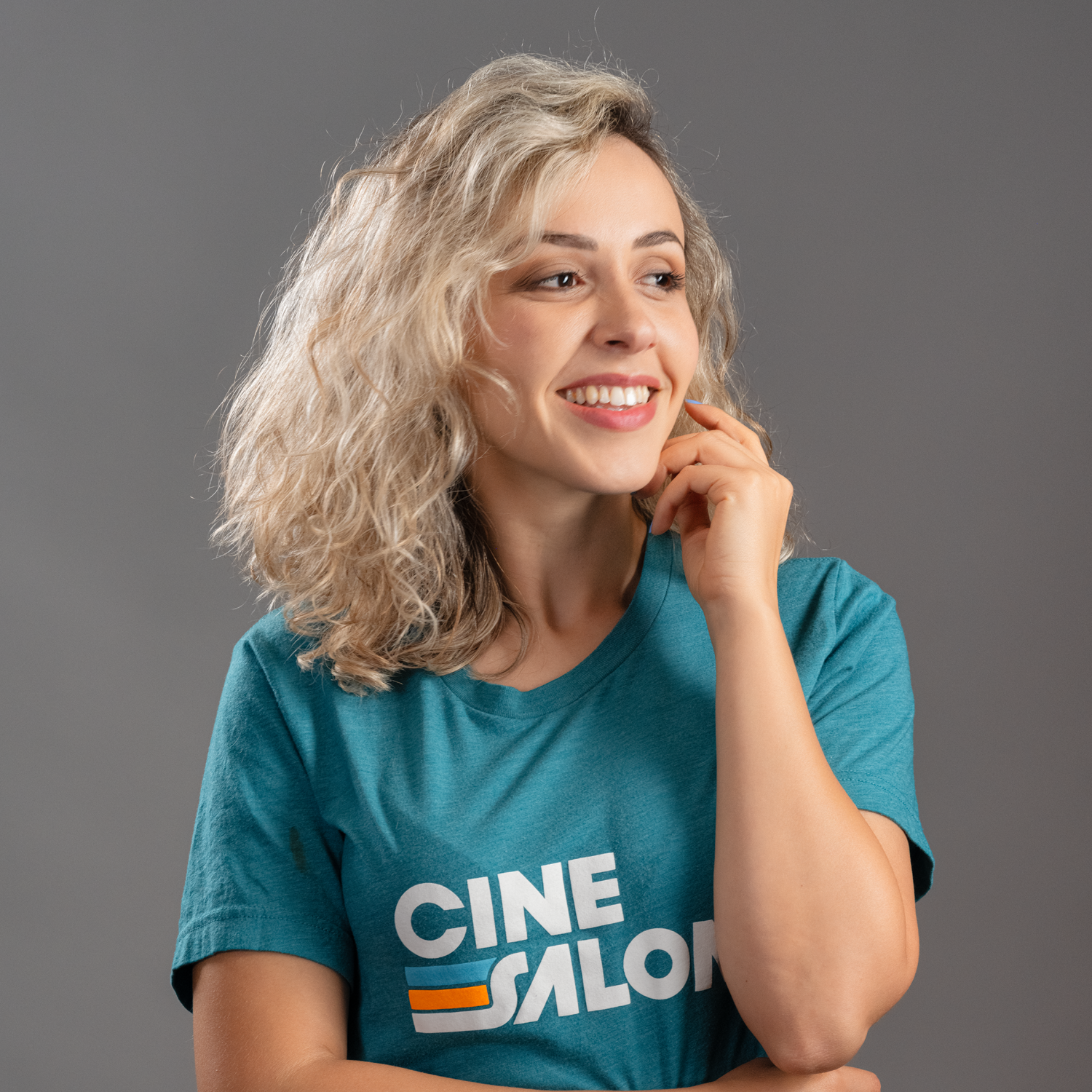 A woman wearing a blue t-shirt that says cine salon