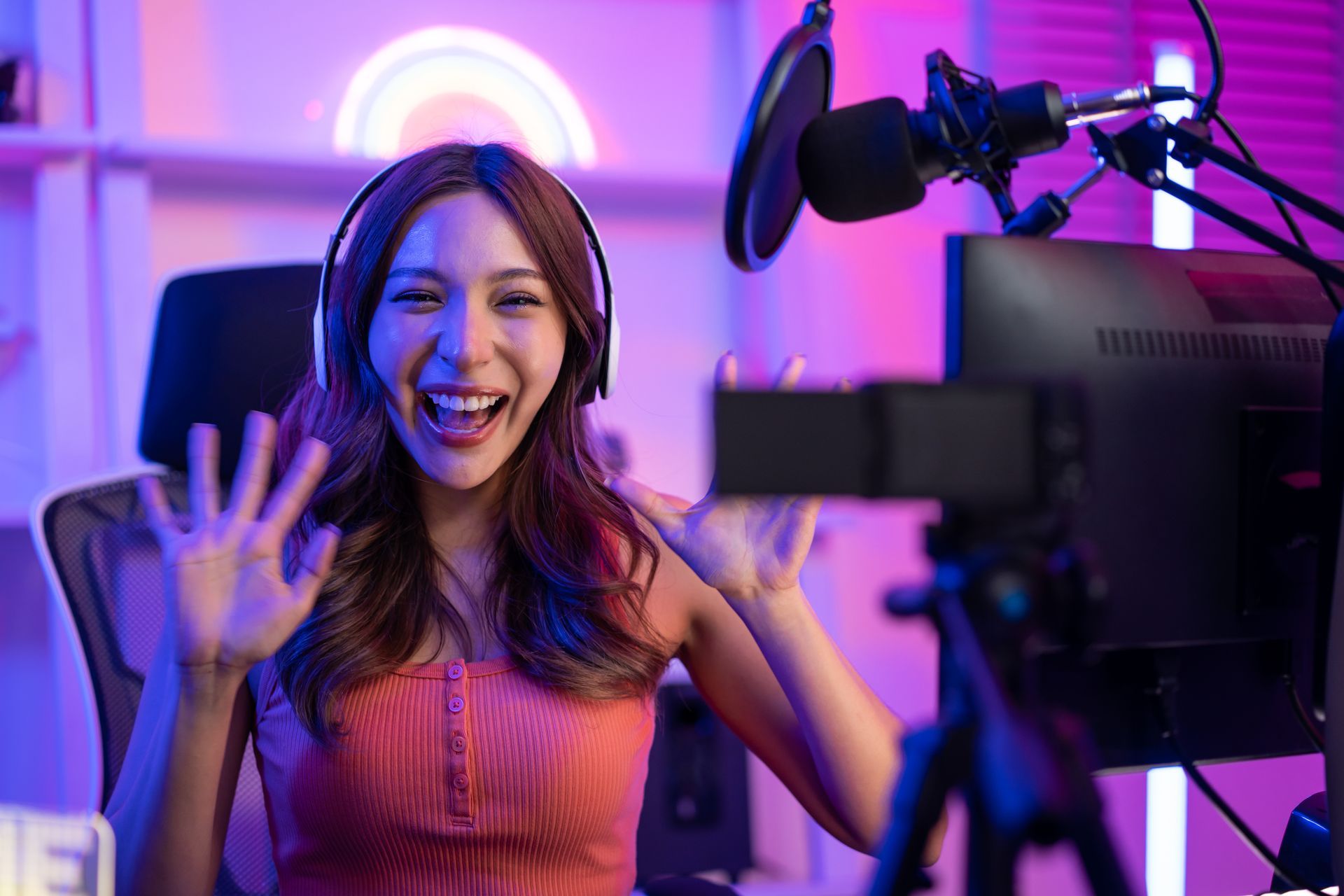 A woman wearing headphones and a microphone is recording a video.