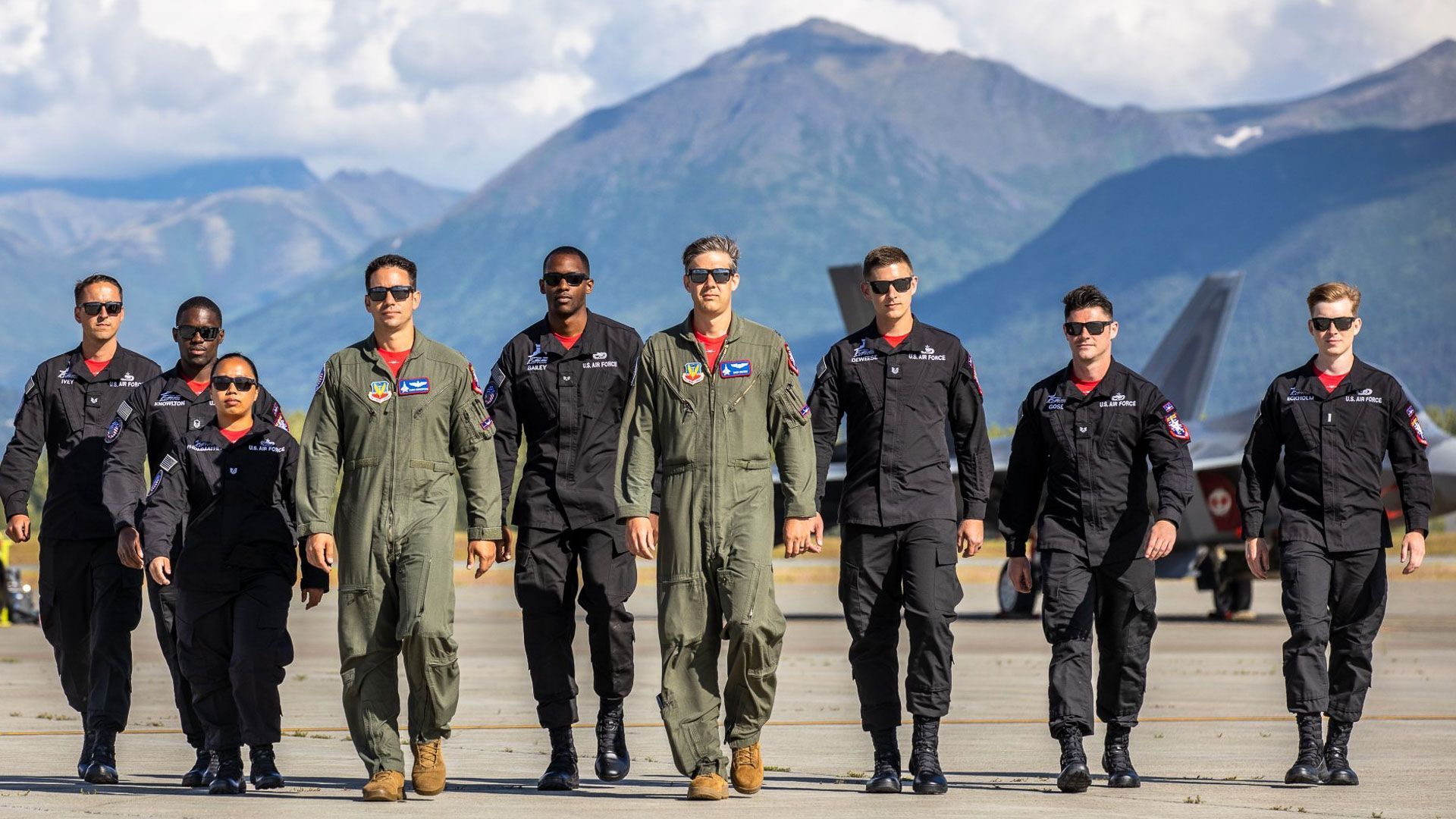 A group of soldiers are standing next to each other on a runway.