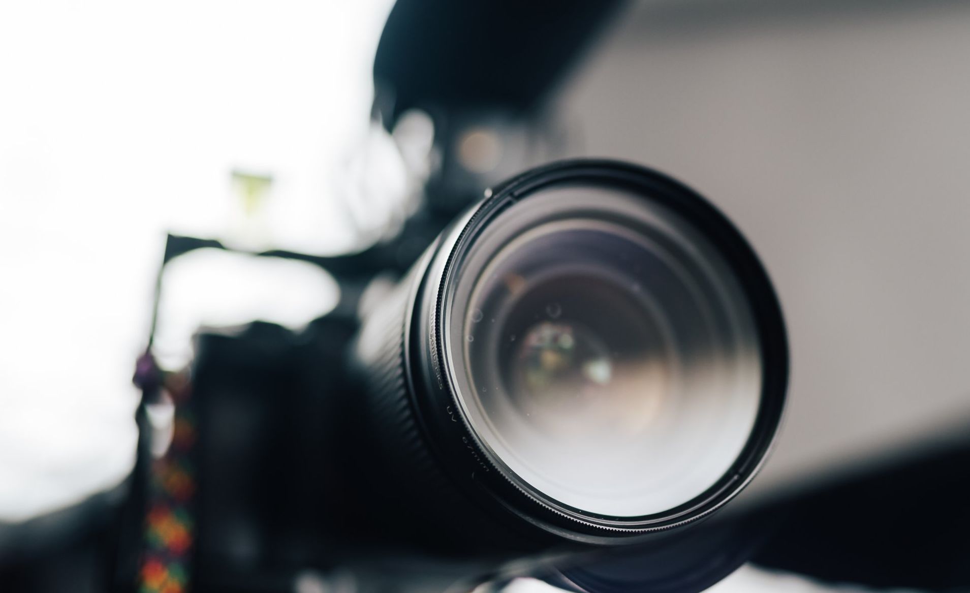 A close up of a camera lens on a table.