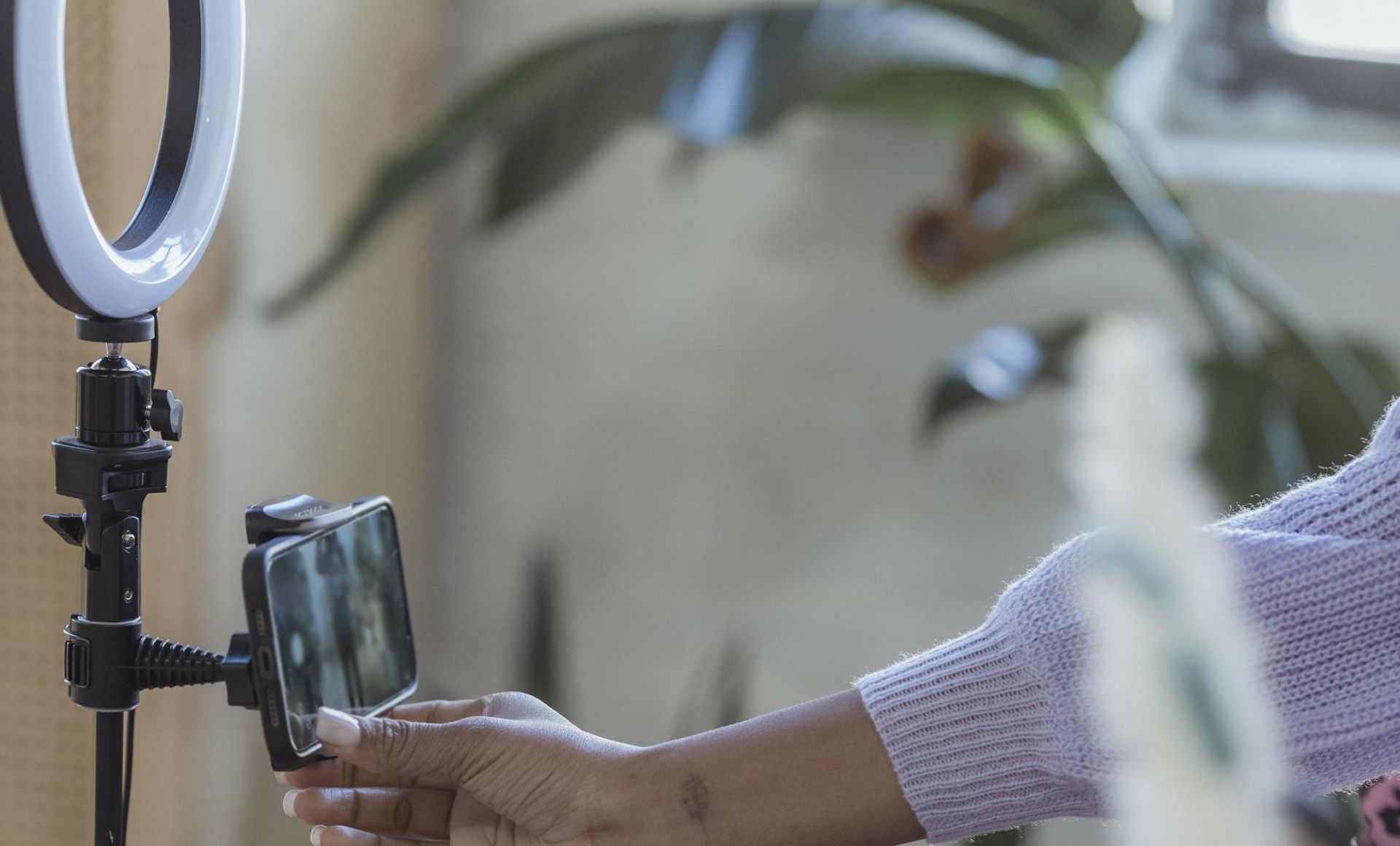 A woman is taking a picture of herself with a cell phone.