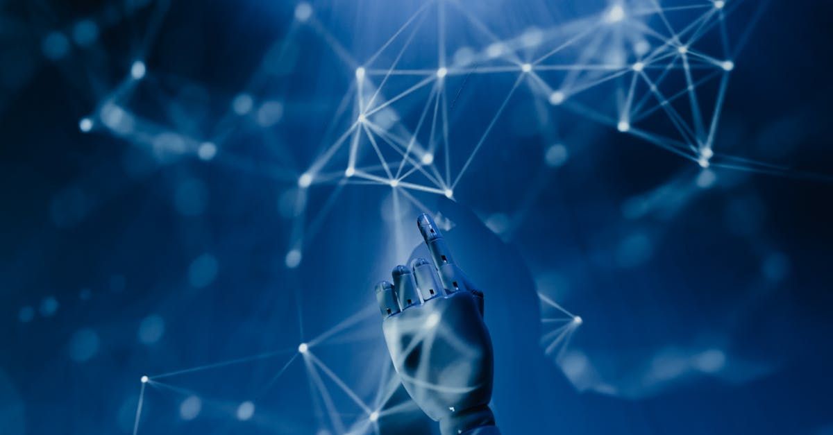 A robotic hand is holding a pen in front of a blue background.
