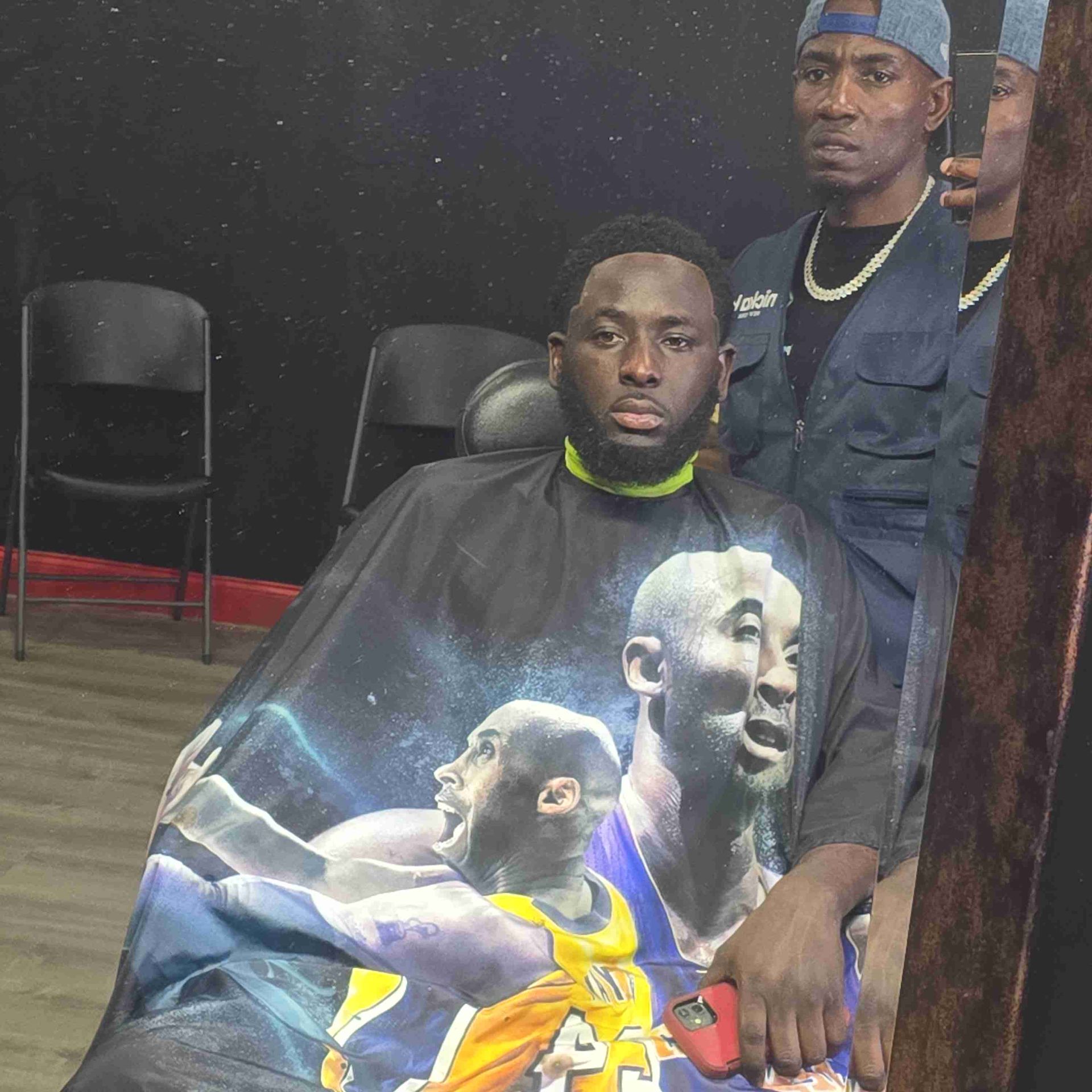 A man is getting his hair cut in a barber shop.