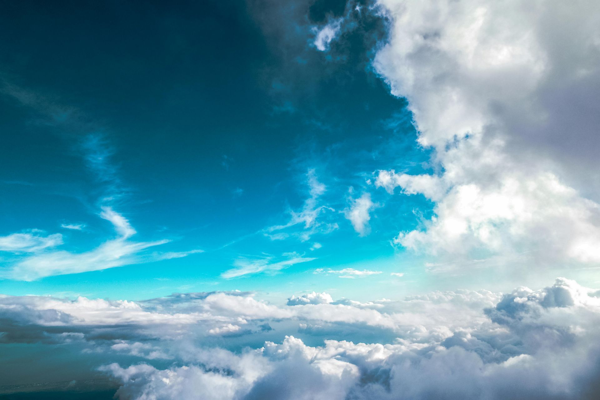 A view of a cloudy sky from an airplane window.
