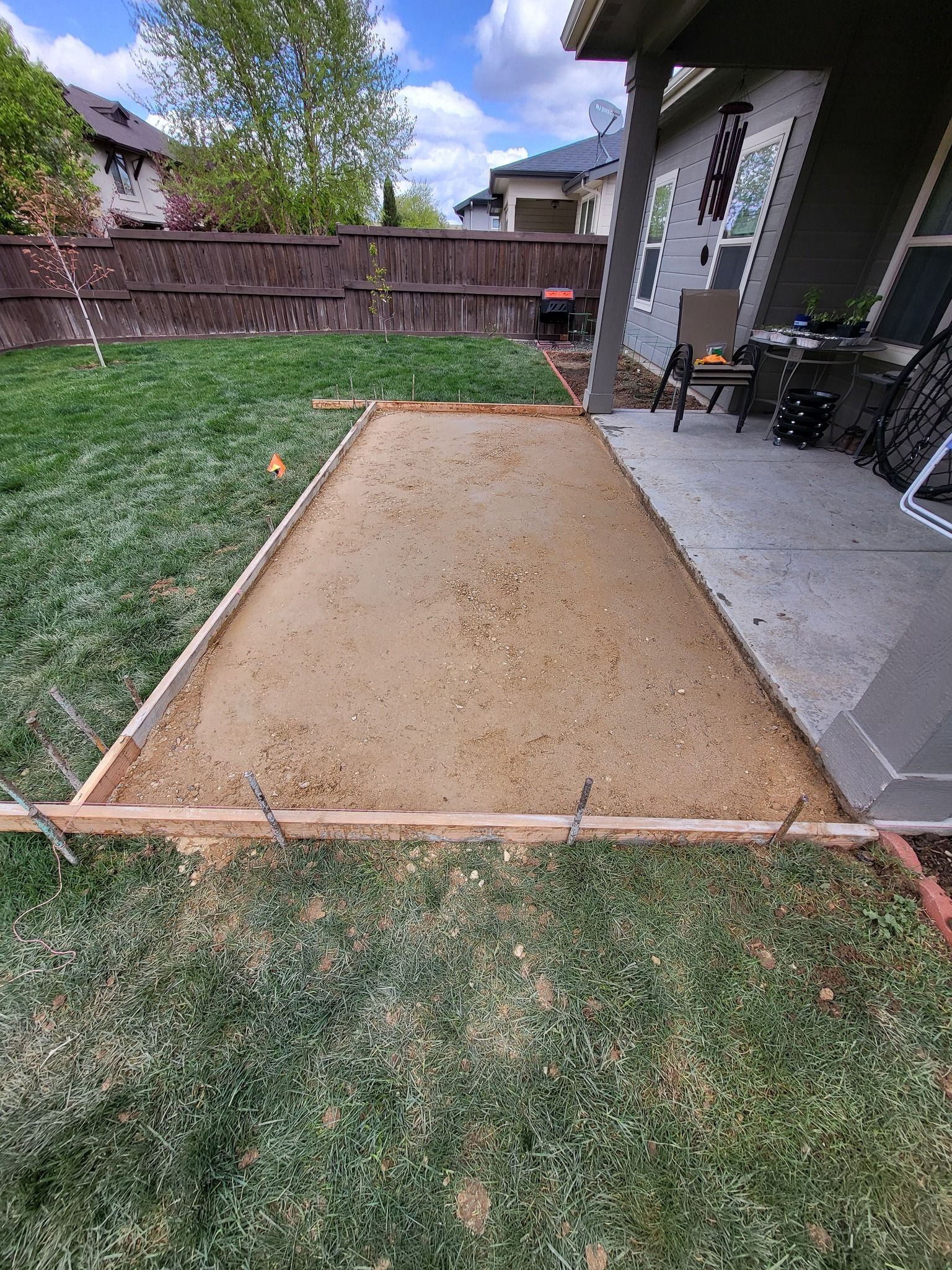 Gravel base leveled for concrete installation beside a home, installed by Waypoint Concrete in Meridian, ID.