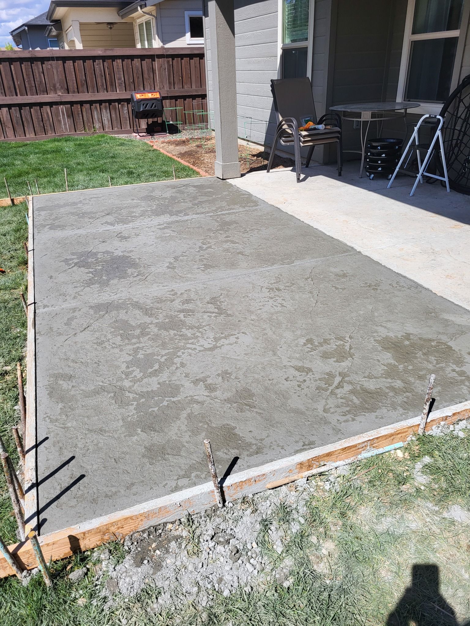 A stone driveway with a metal gate leading to a house