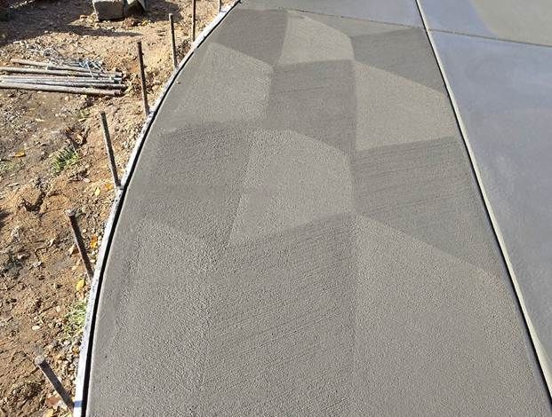 Broom finish concrete technique in a driveway.