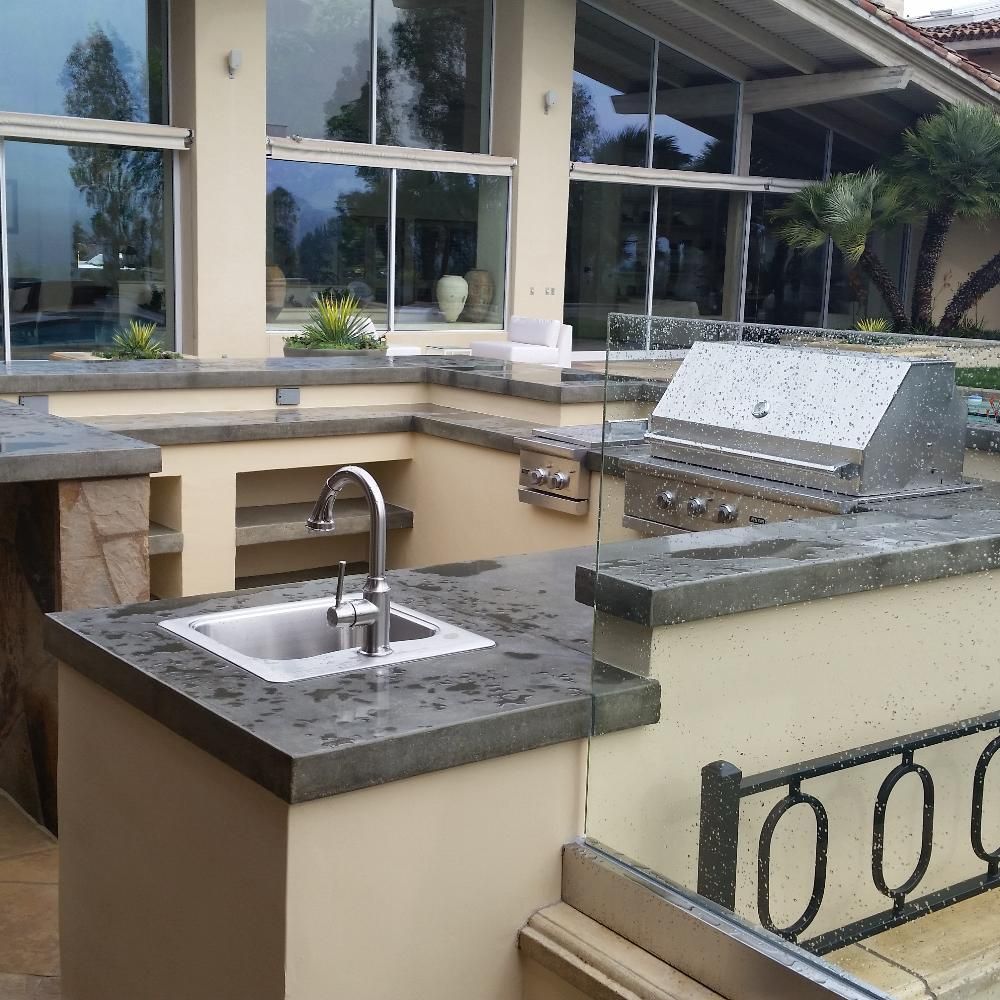 Waypoint Concrete poured dual-surface outdoor kitchen countertops in a lakeside residence in Cascade, Idaho.