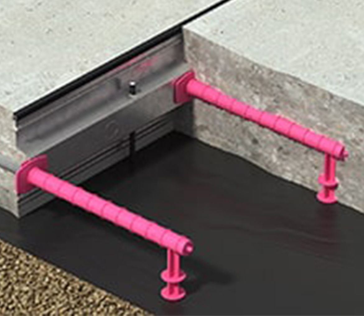A pink railing is attached to a concrete wall.