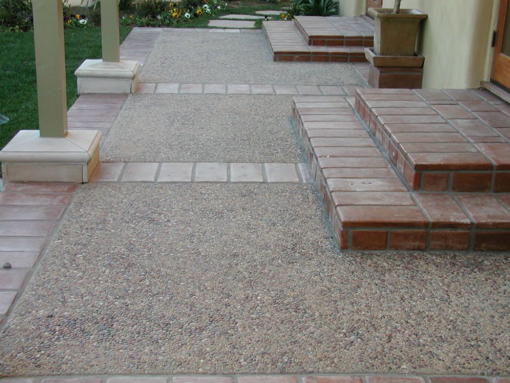 Waypoint Concrete poured textured concrete walkways and steps with brick accents in Caldwell, Idaho.