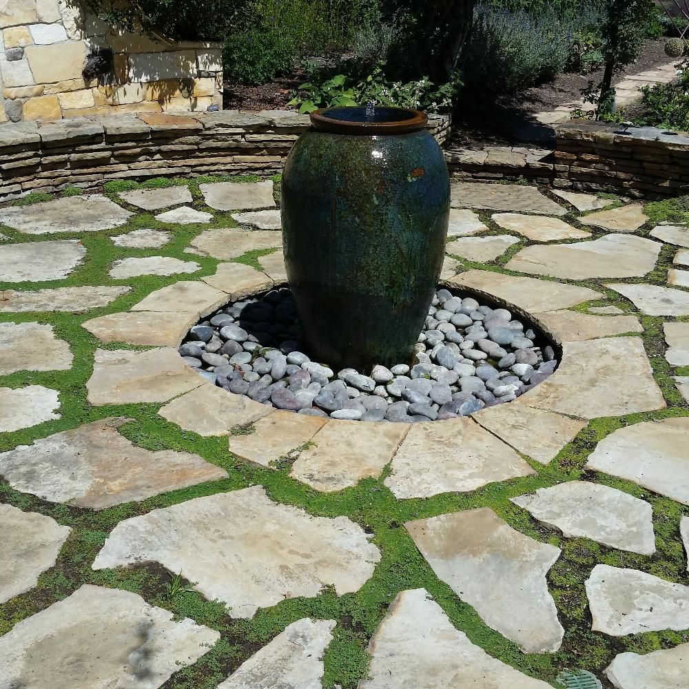 Waypoint Concrete laid irregular stone pavers around a water feature in a courtyard in Garden City, Idaho.