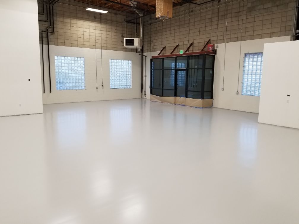 Waypoint Concrete coated a polished white epoxy floor for a clean commercial showroom in Eagle, Idaho.