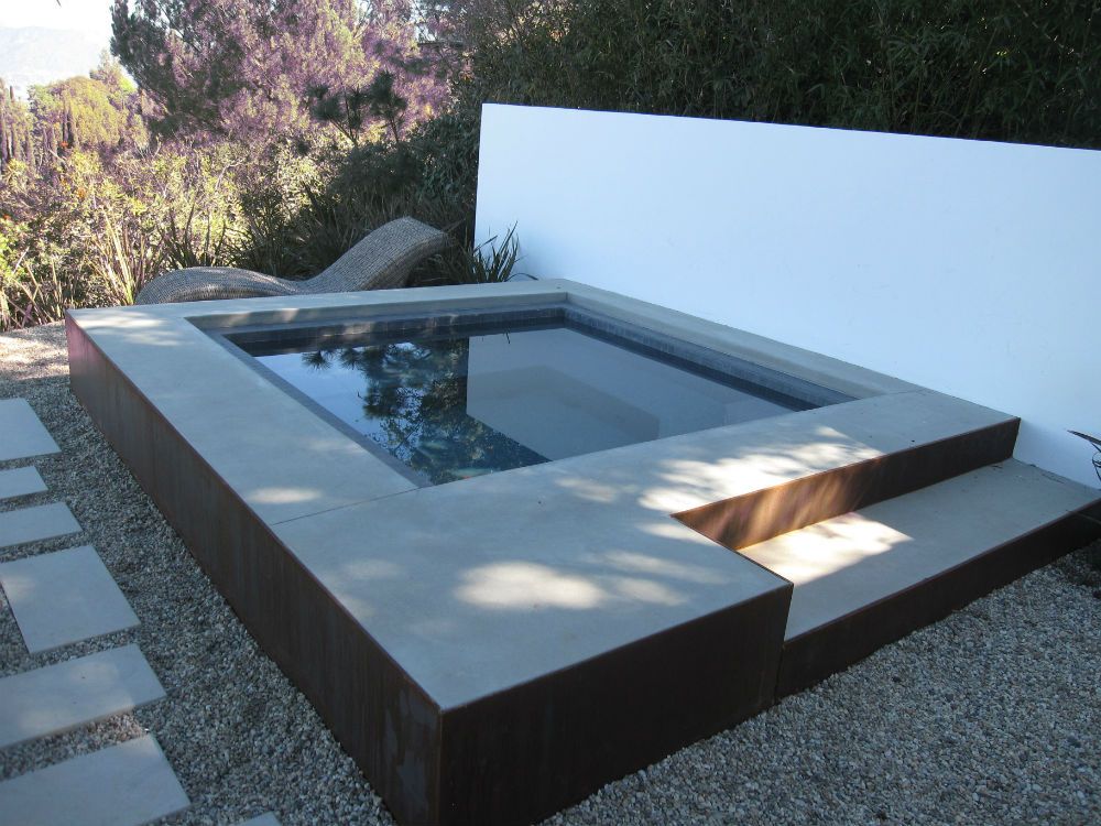 Waypoint Concrete installed a floating concrete bench and water feature patio design in Garden City, Idaho.
