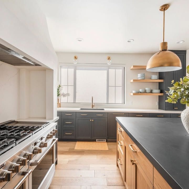 Modern kitchen with gray cabinets, wooden island, and gold accents.