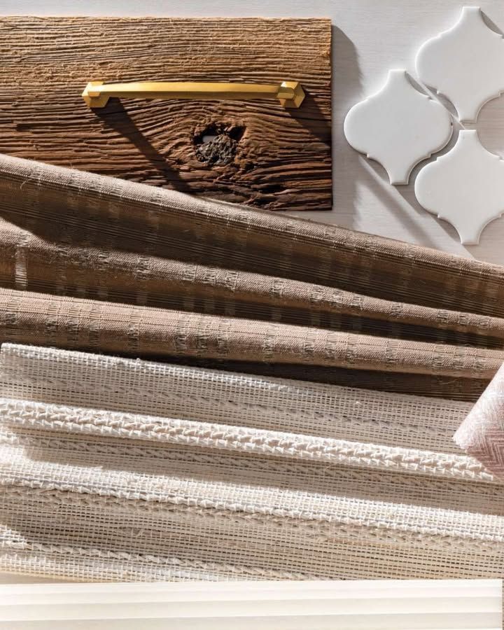 Wood and fabric texture board with gold hardware and white tile accents.
