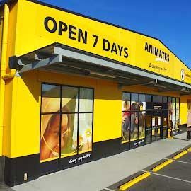 A yellow and black building with a sign that says `` open 7 days ''.
