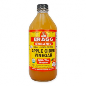 A bottle of bragg organic apple cider vinegar with the mother