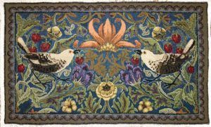 A rug with two birds and flowers on it