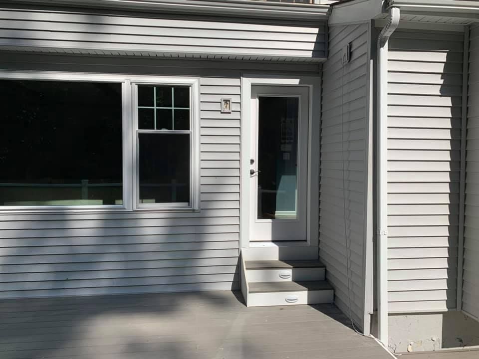 A white house with a white door and stairs