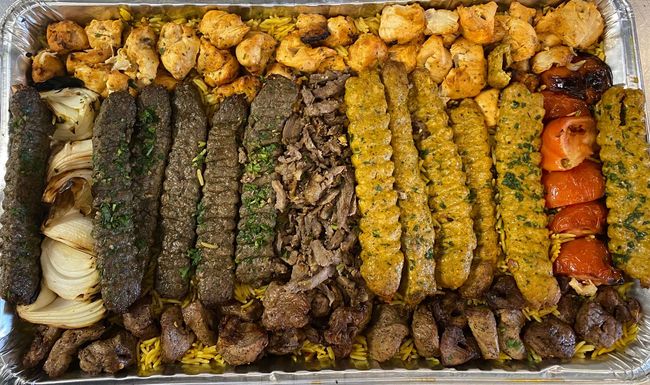 A large tray filled with a variety of meats and vegetables.