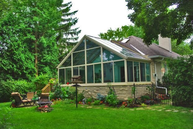 A house with a large sunroom in the backyard
