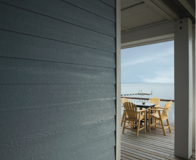 A table and chairs on a deck overlooking the ocean