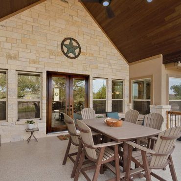 A patio with a table and chairs and a star on the wall