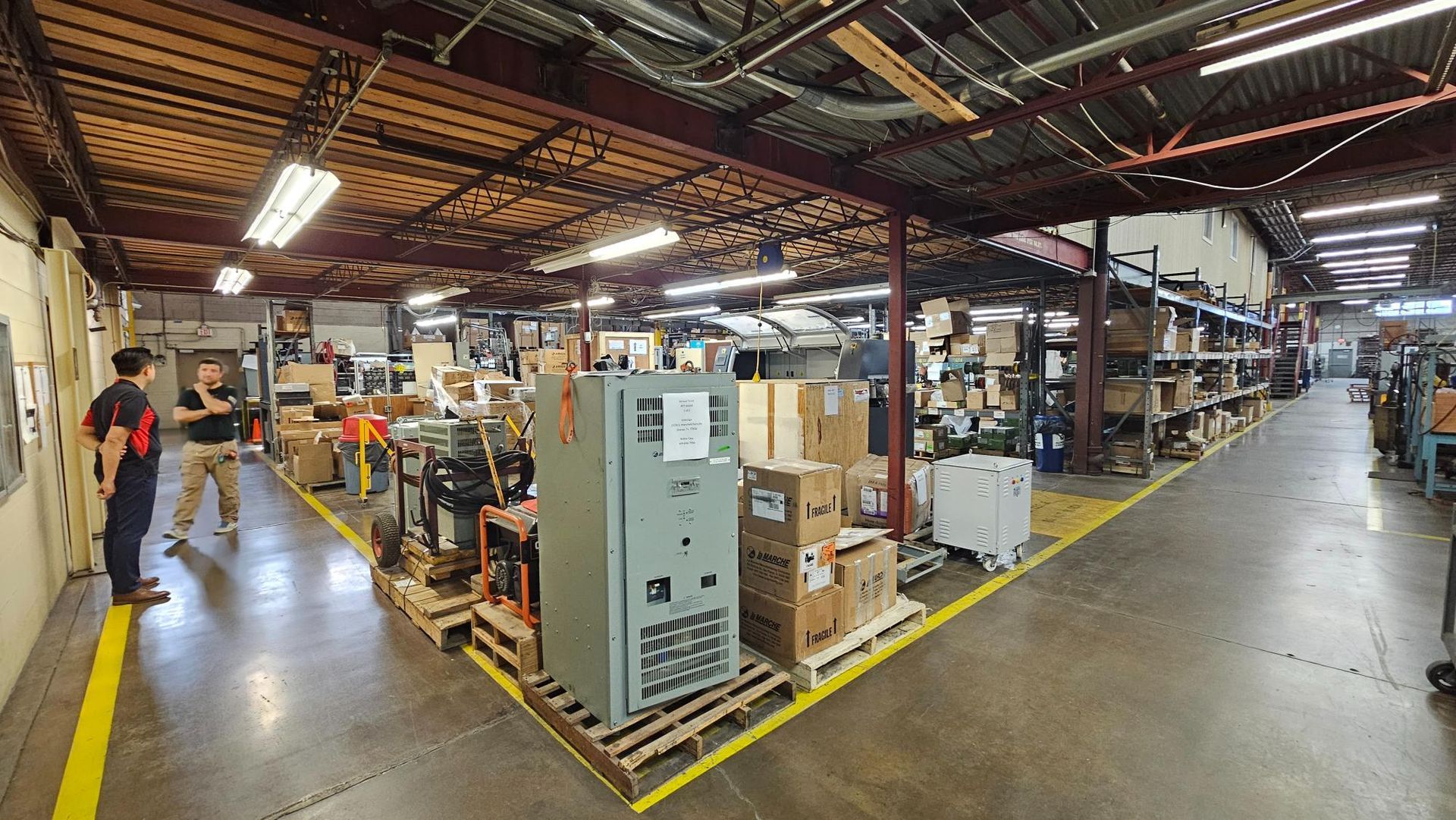 A large warehouse filled with lots of boxes and machinery.
